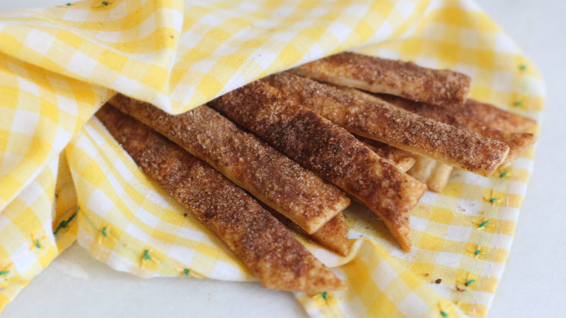 Strips of baked pie dough dusted with sugar and pumpkin pie spice
