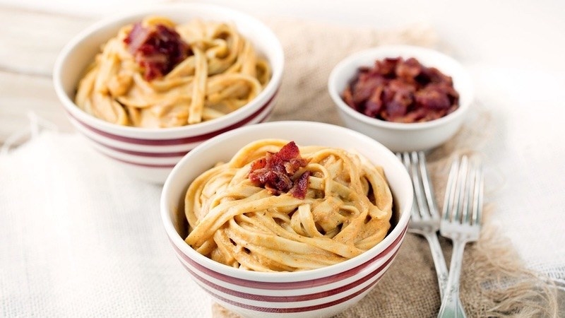 Two bowls of pumpkin pasta on a table