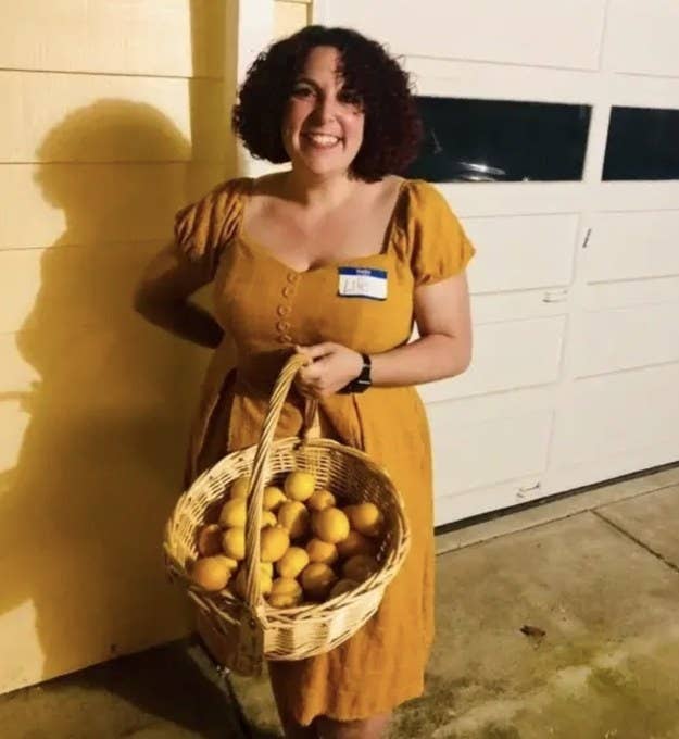 Someone in a yellow dress, holding a basket of lemons, wearing a name tag that says &quot;Life&quot;