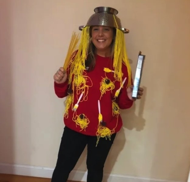 person wearing a strainer and fake pasta on their head