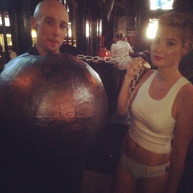 A couple dressed as Miley Cyrus and her wrecking ball