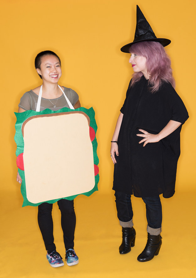 One person in a sandwich outfit and one person in a witch outfit