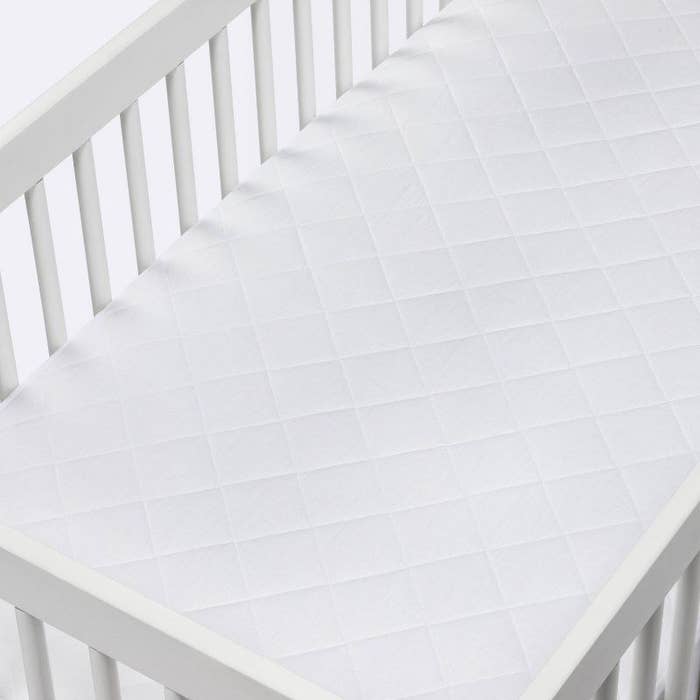 the mattress cover in a crib