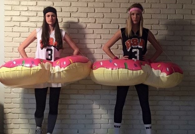 Two people dressed like donuts also wearing basketball jerseys