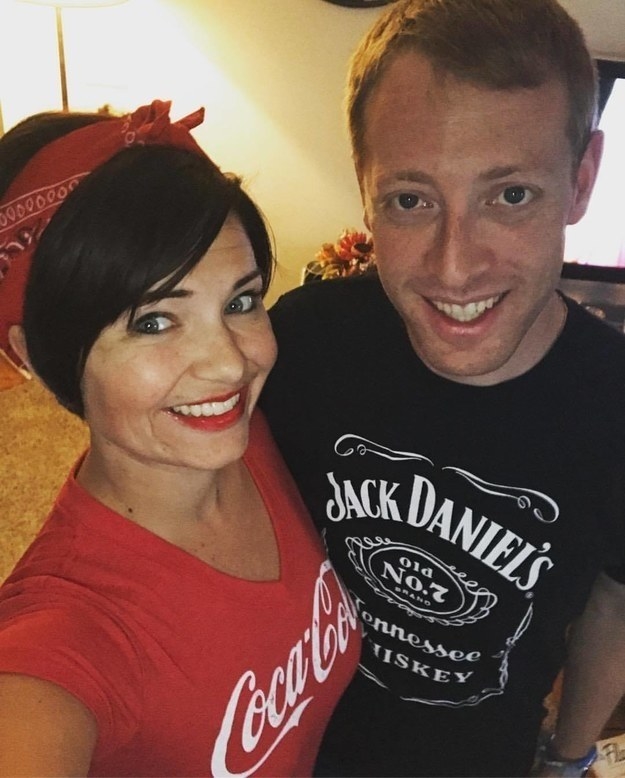 One woman wearing a Coca-Cola shirt and one man wearing a Jack Daniels shirt