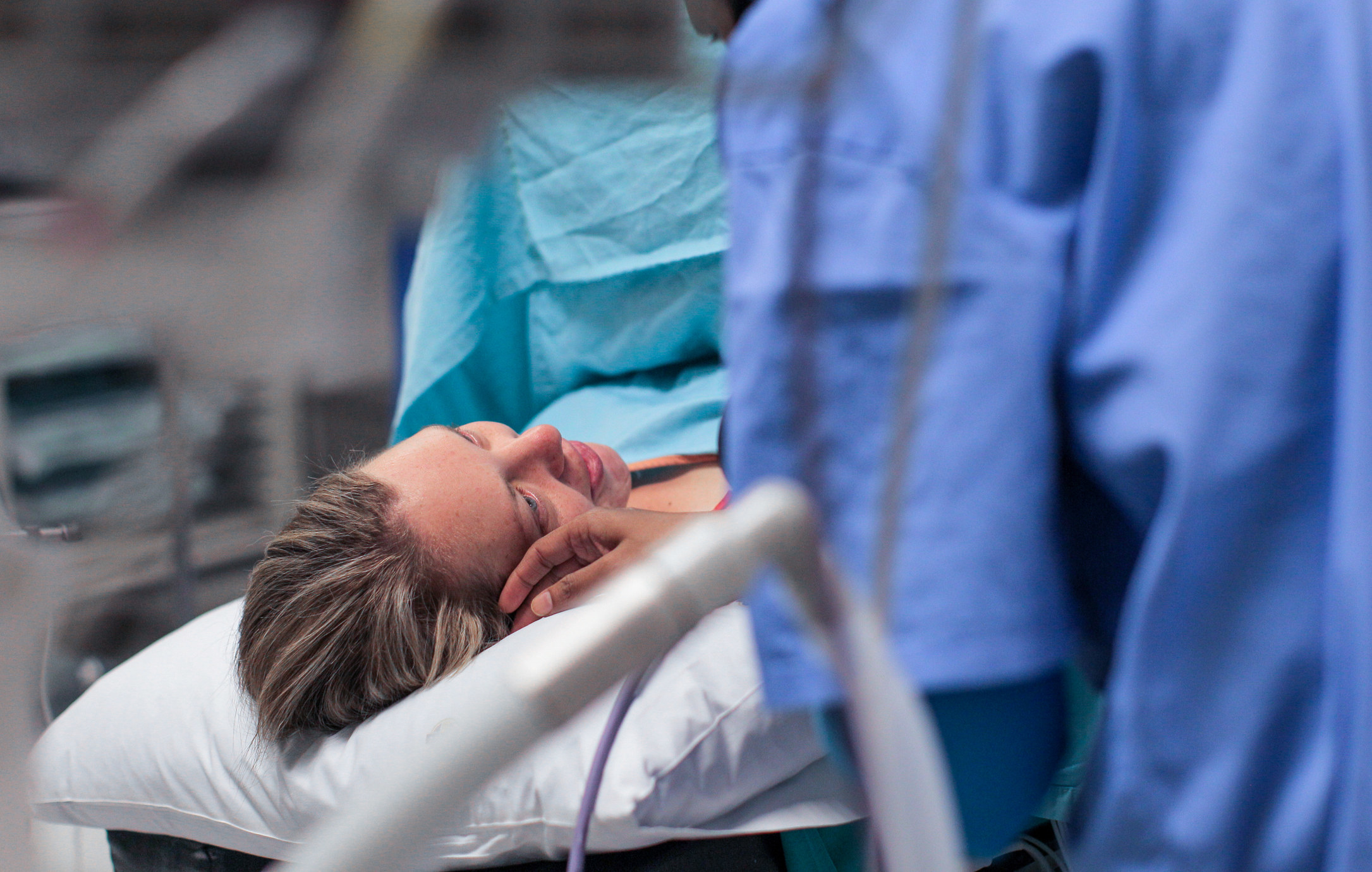 Patient lying in hospital bed during C-section