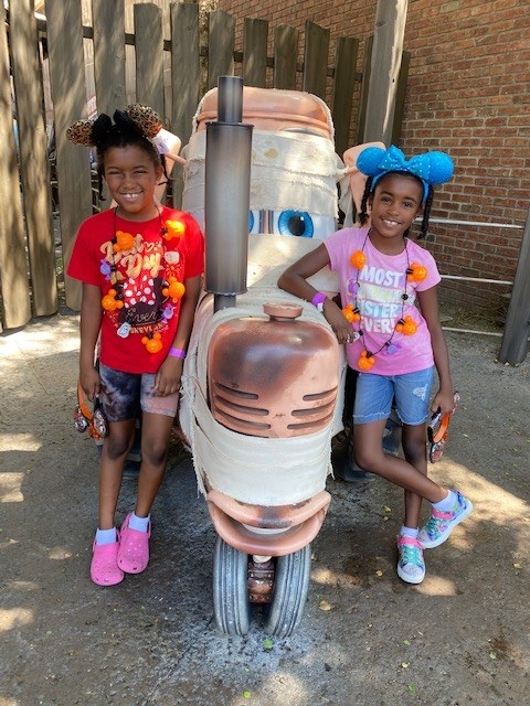 the author&#x27;s daughters posing with Mater