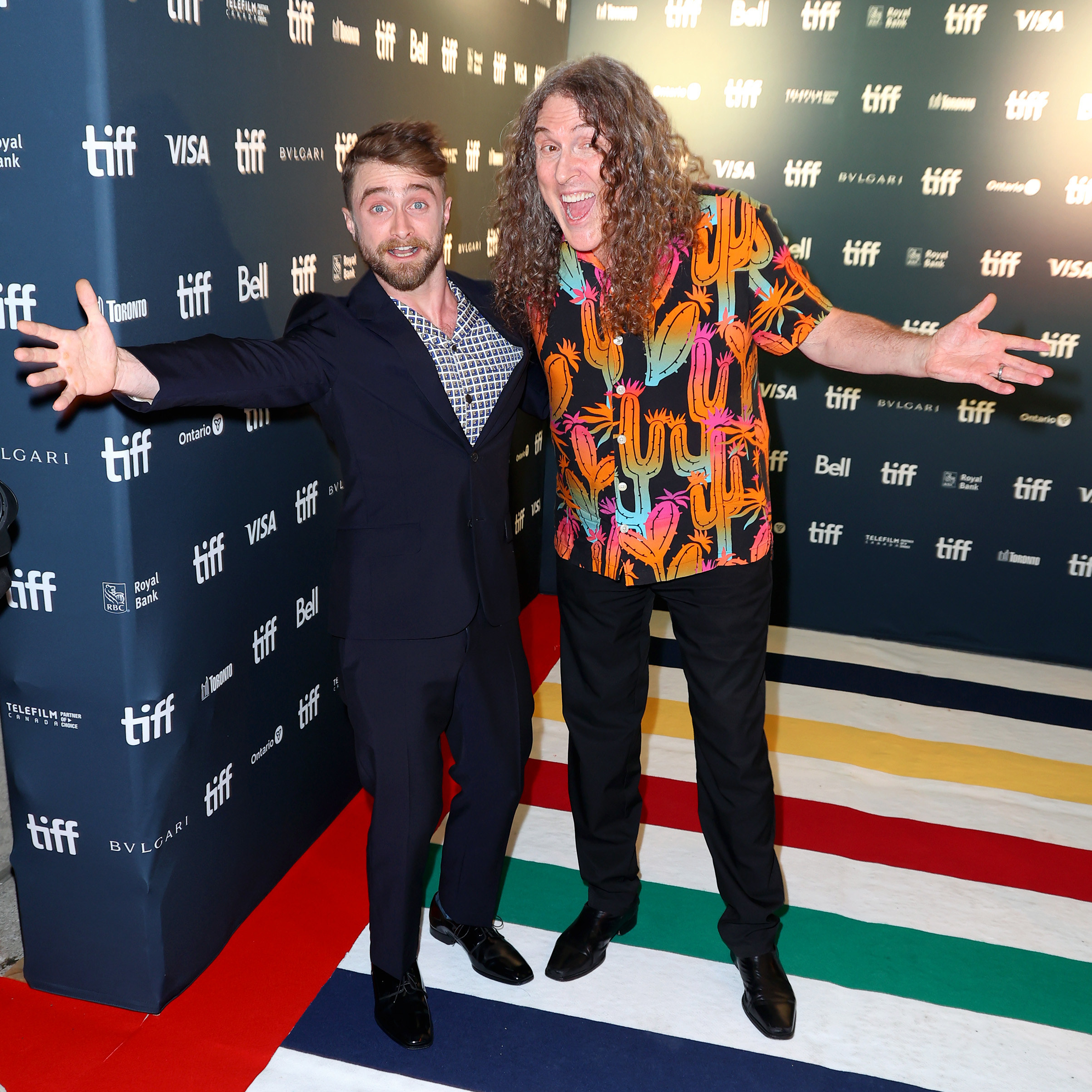 Daniel and Al do a silly pose together for photographers at a red carpet event