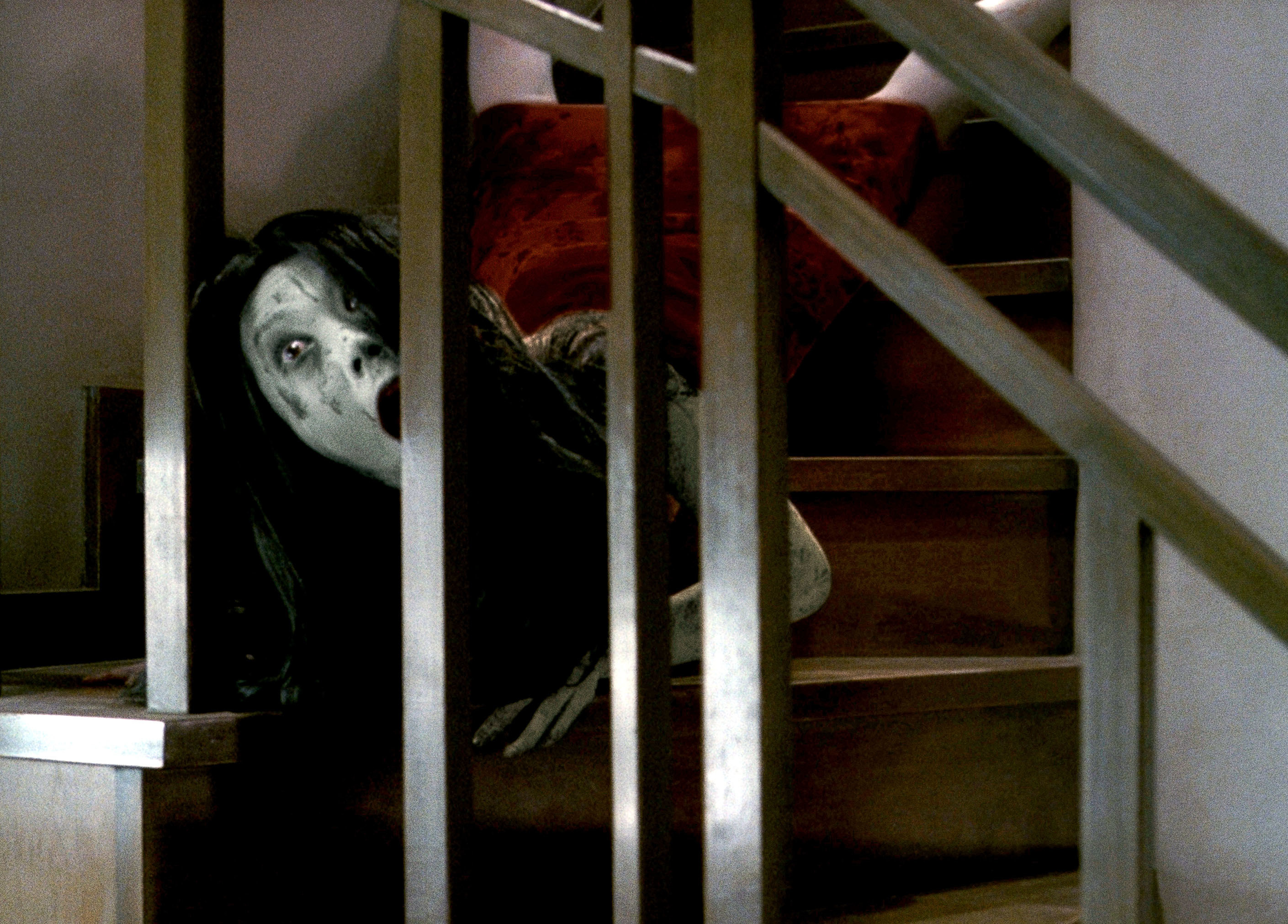 A scream girl is contorted on the stairs