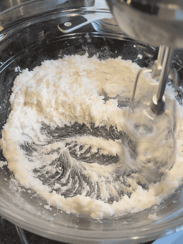 creaming together shortening and sugar with an electric hand mixer