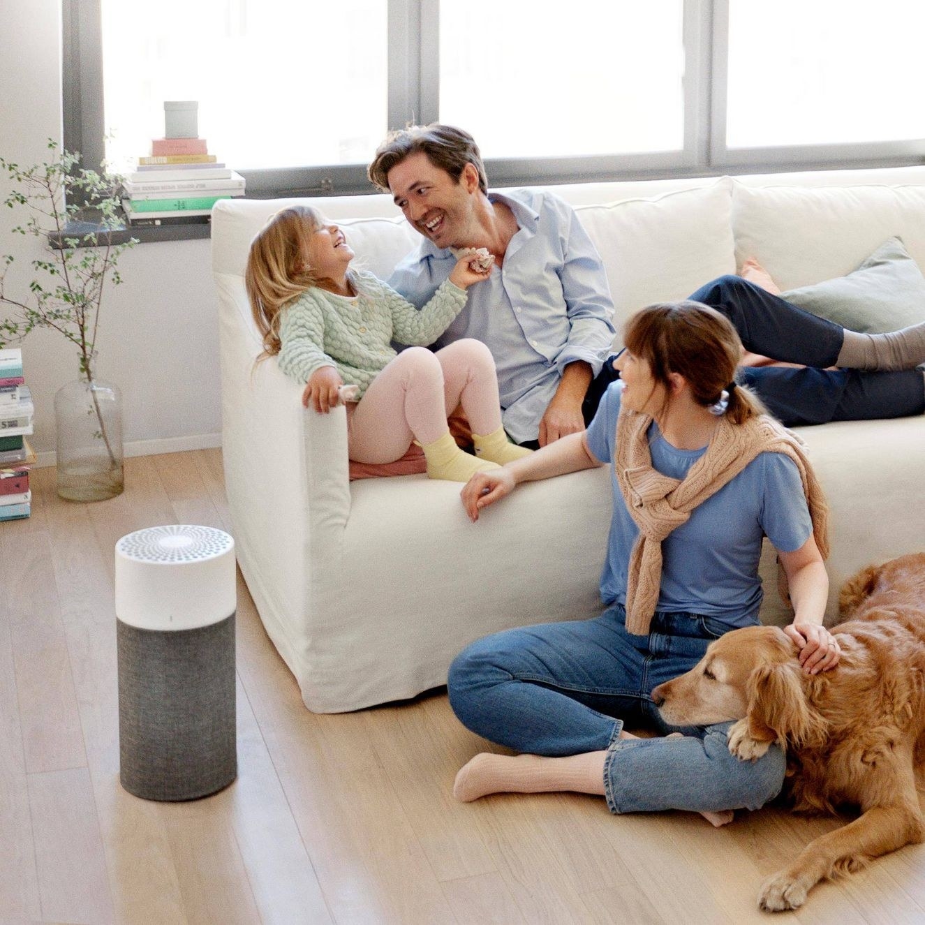 The air purifier in a living room with a model family