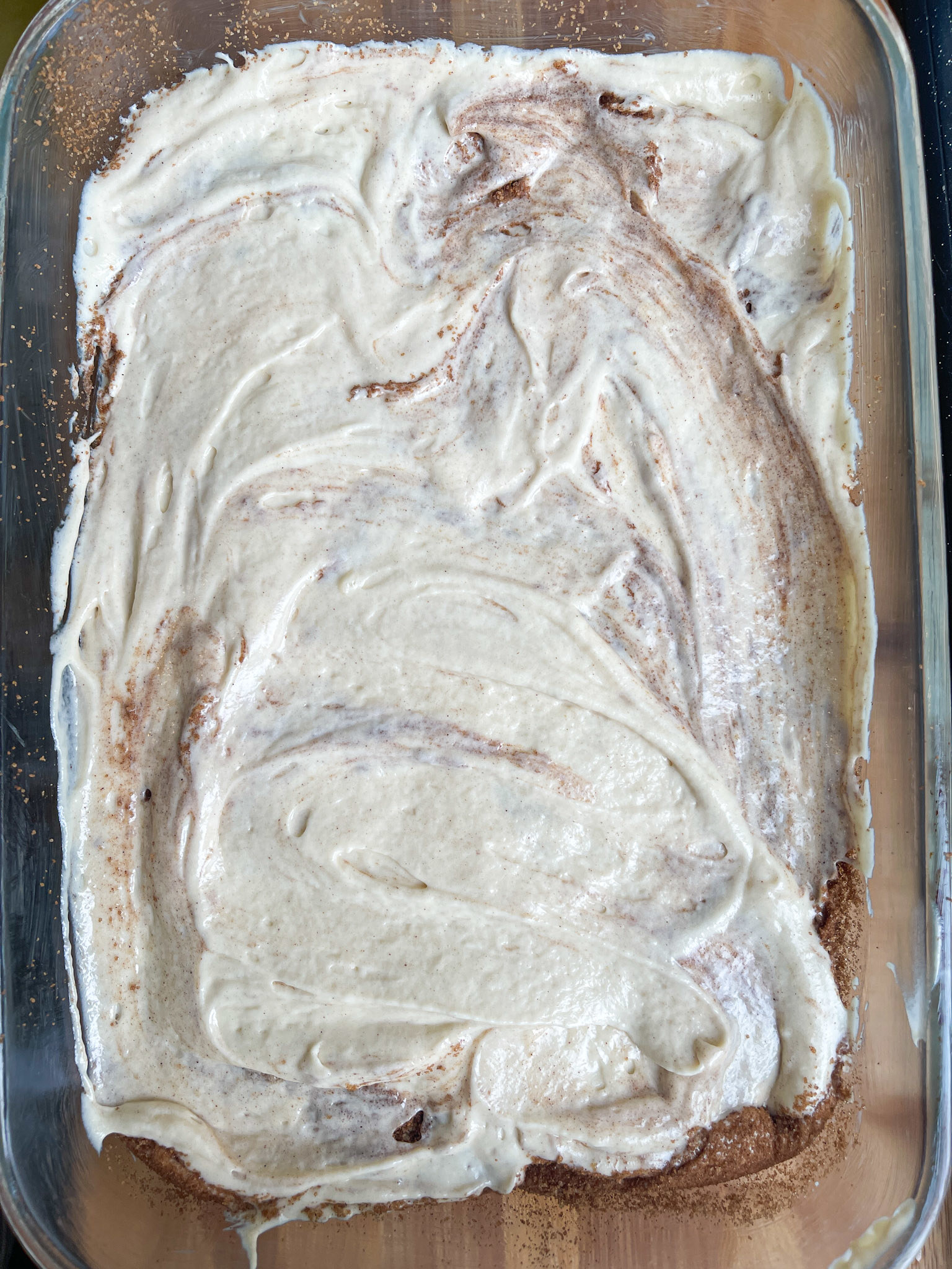 cake batter laid out in baking dish, smoothed across the top