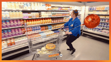 woman throwing a bottle of iced coffee into her cart