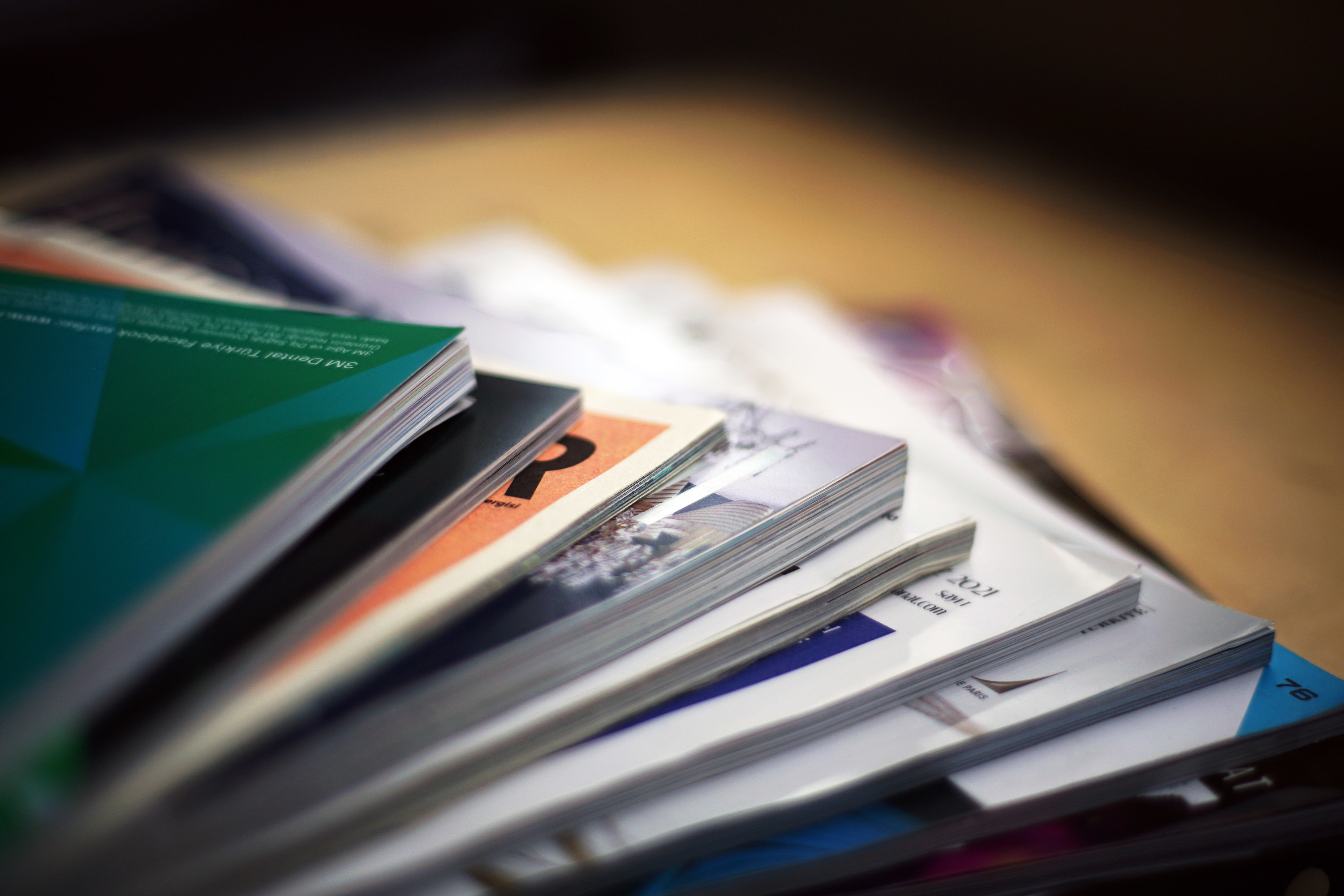 close-up of the corner of a pile of fanned-out magazines