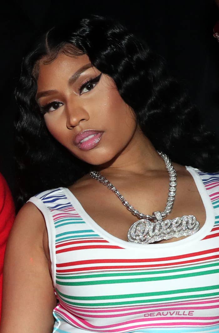 A closeup of Nicki wearing a diamond chain that says &quot;Queen&quot;