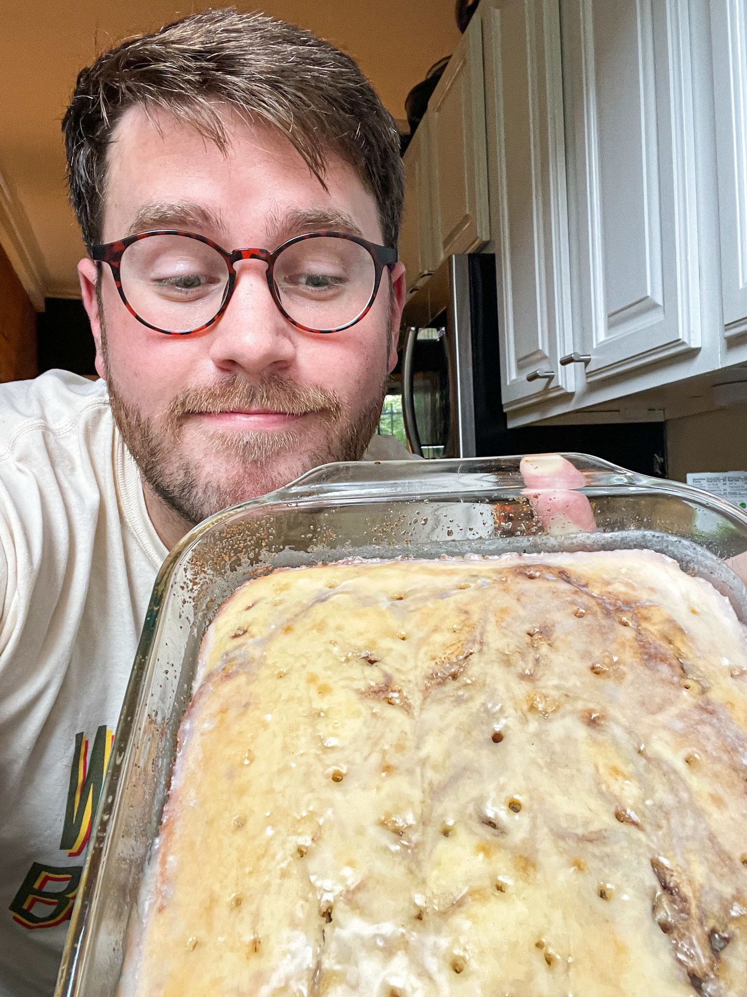 author holding up the baked cake and looking down at it