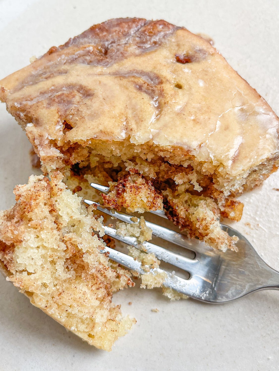 cutting into a slice of cake using a fork