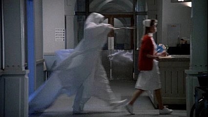 A creature in all white jumps out and follows a nurse