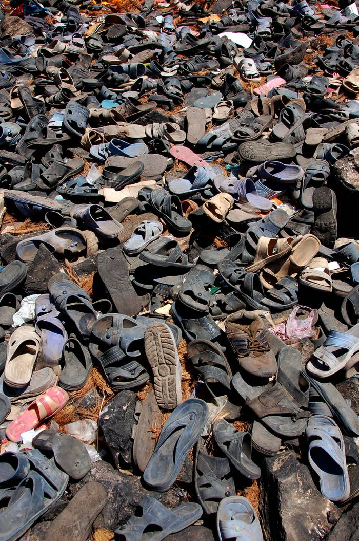 A bunch of shoes in a landfill
