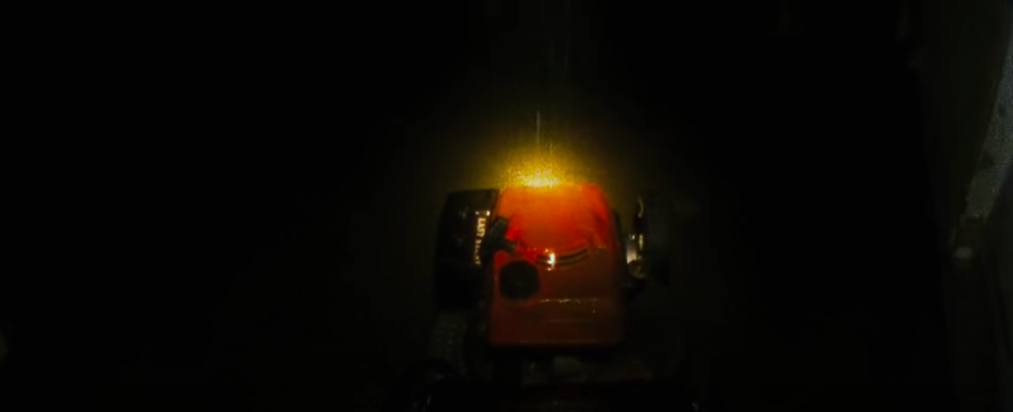 A lawnmower moving in the dark