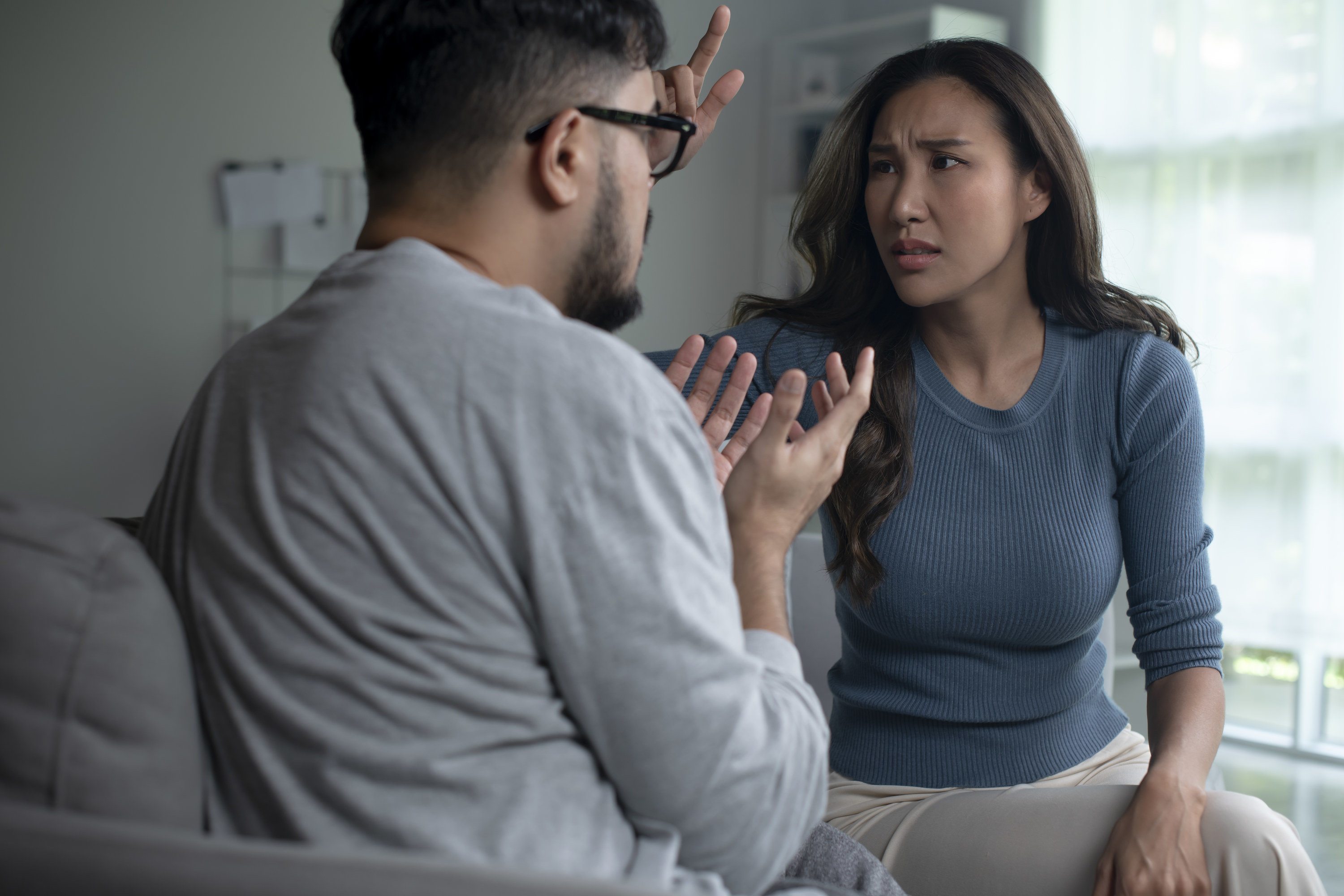 Asian couple arguing shouting blaming each other of problem, husband and wife fighting at home, relationship Problems concept