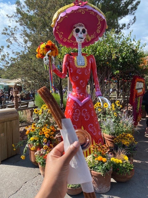 author holding up the churro