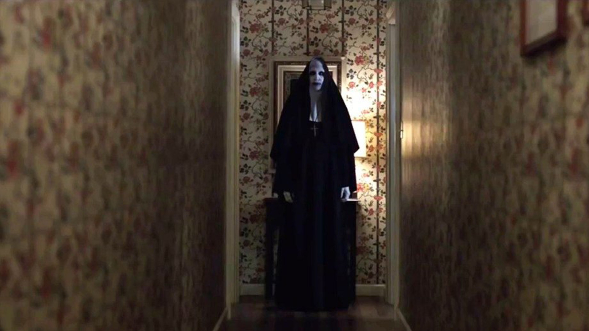 A nun standing at the end of a hallway