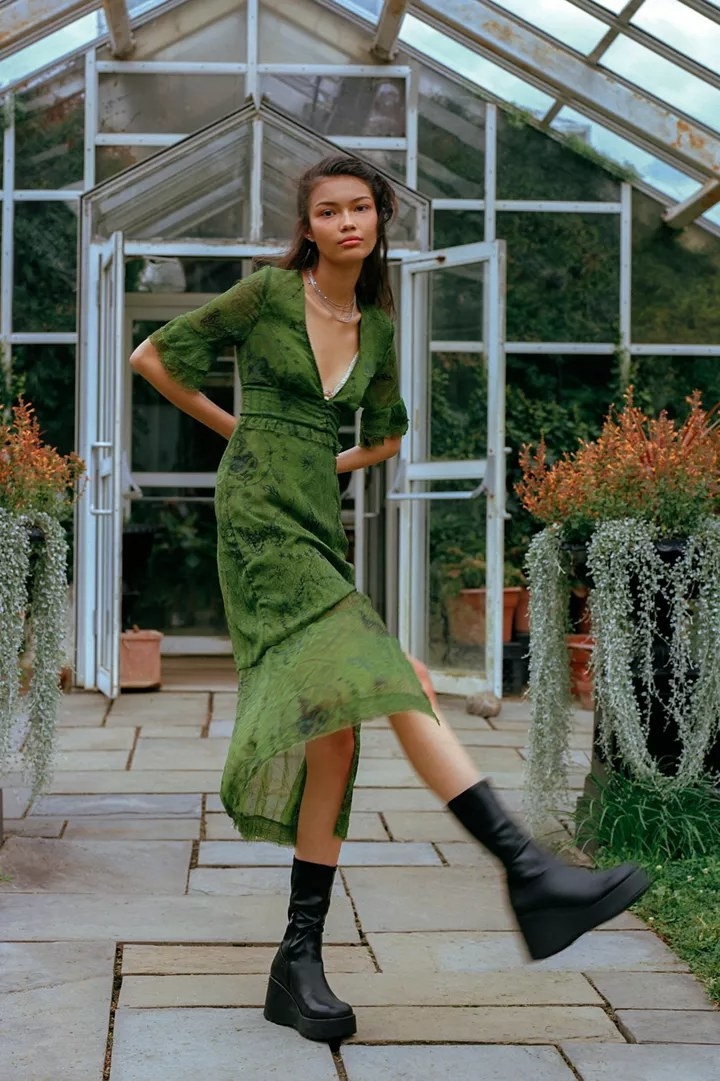 A model wearing the midi dress in the color Green Multi