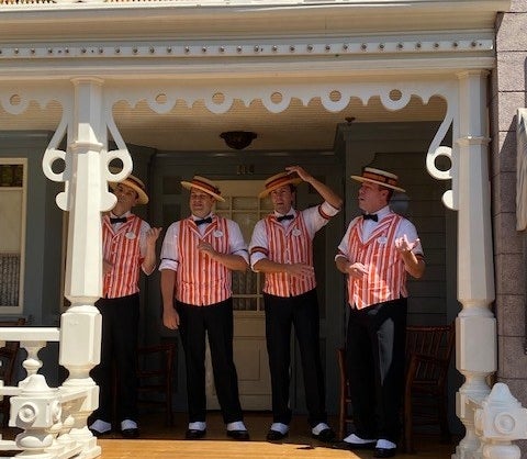 men singing on a porch