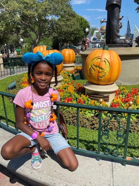 author&#x27;s daughter posing in front of the pumpkin