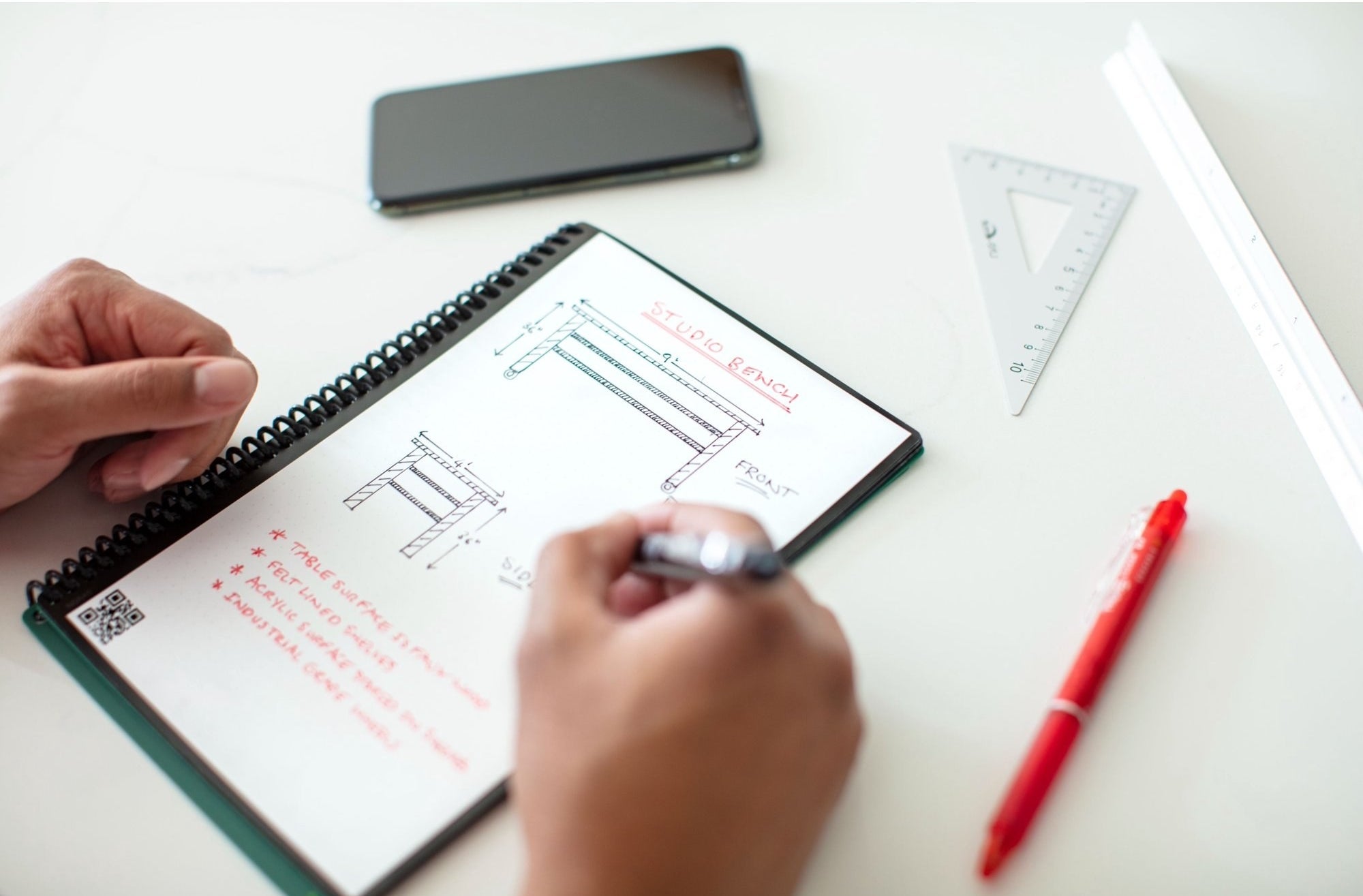 A model using a green notebook