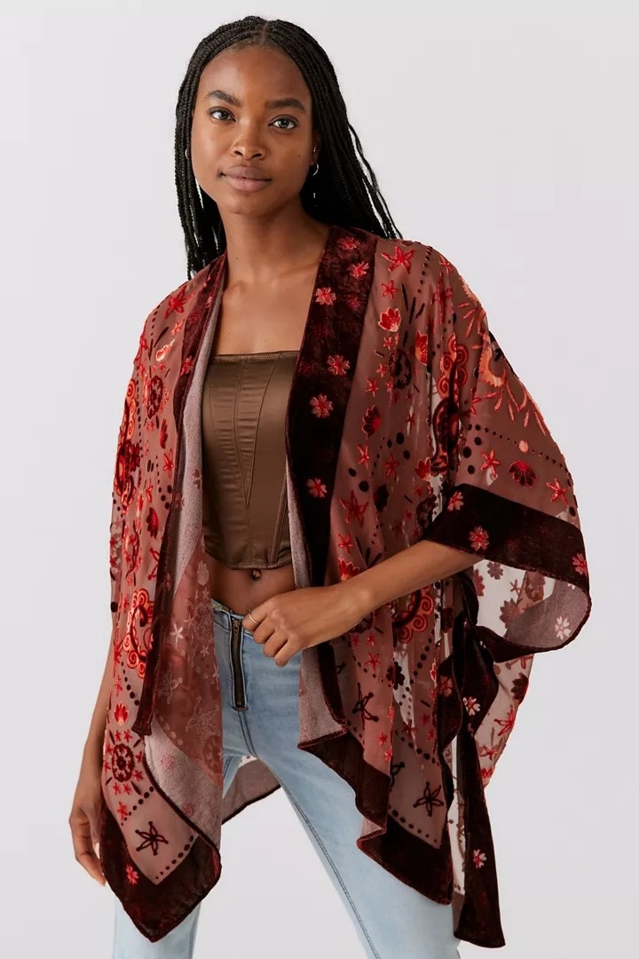 A model wearing the ruana in the color Brown