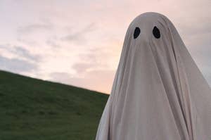 A sheet ghost walks across a hill