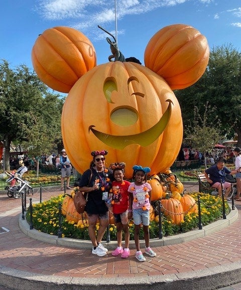 author and her kids in front of the large pumpkin