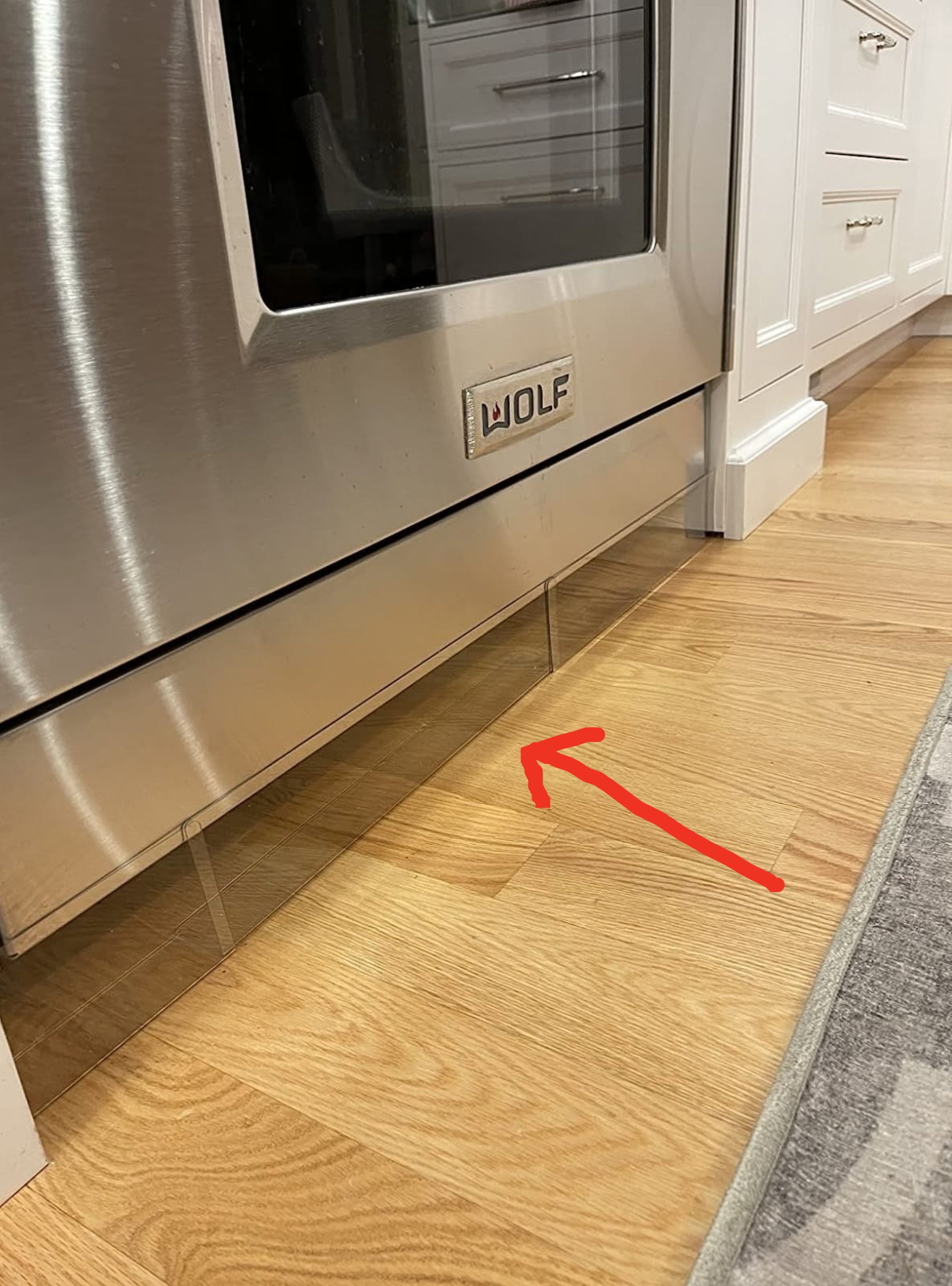 Reviewer&#x27;s oven with the clear blockade under it and a red arrow pointing to it