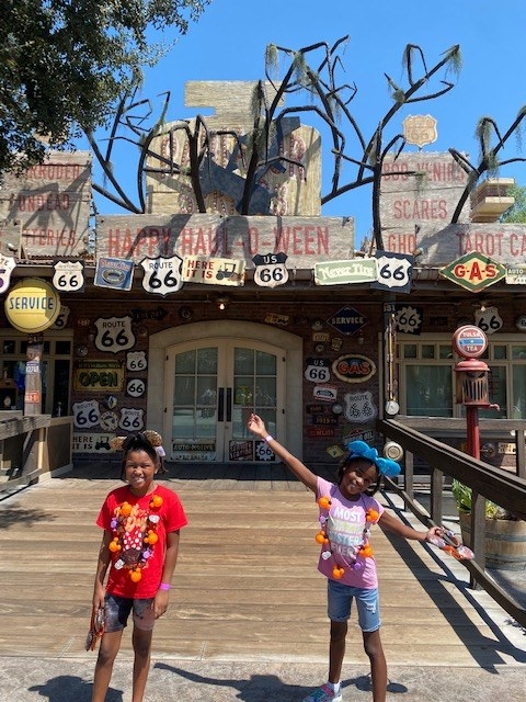 the author&#x27;s daughters in front of the cars-themed motel