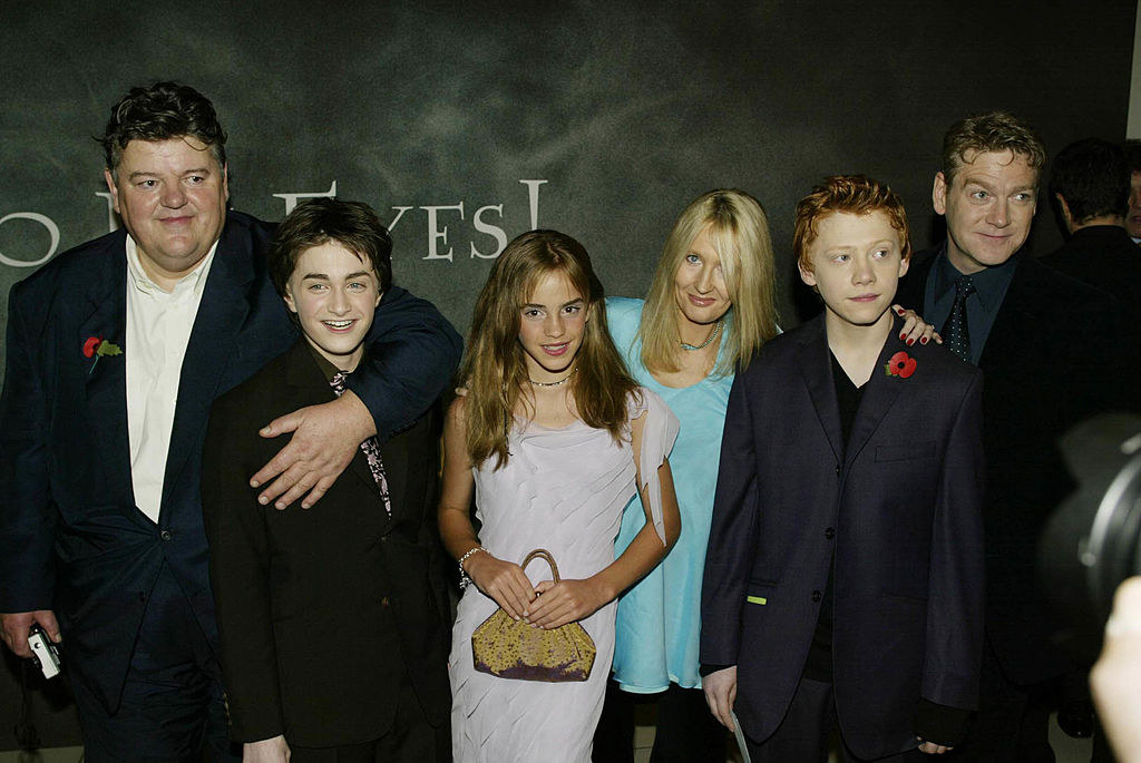 closeup of the cast with Robbie at an event
