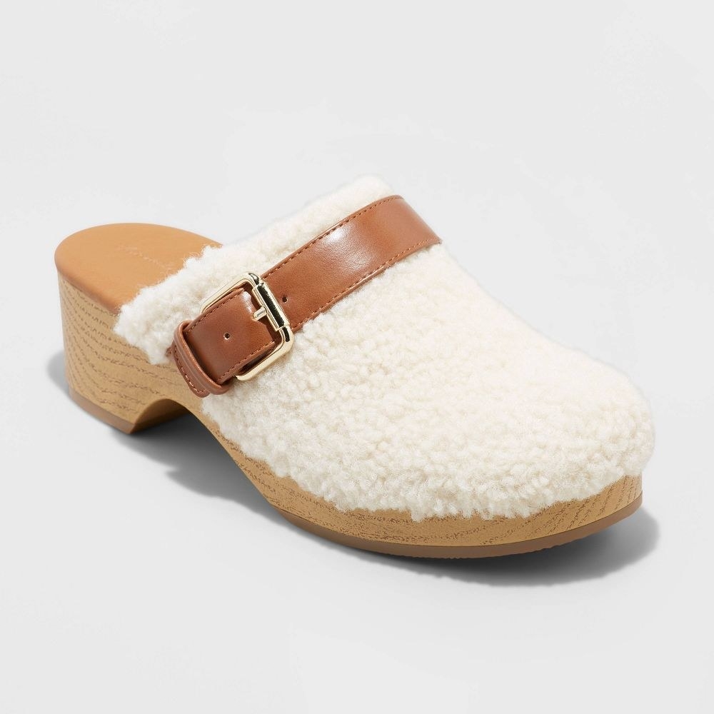 the slip on clog with white fur and brown buckle