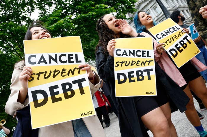 People holding up &quot;Cancel Student Debt&quot; signs