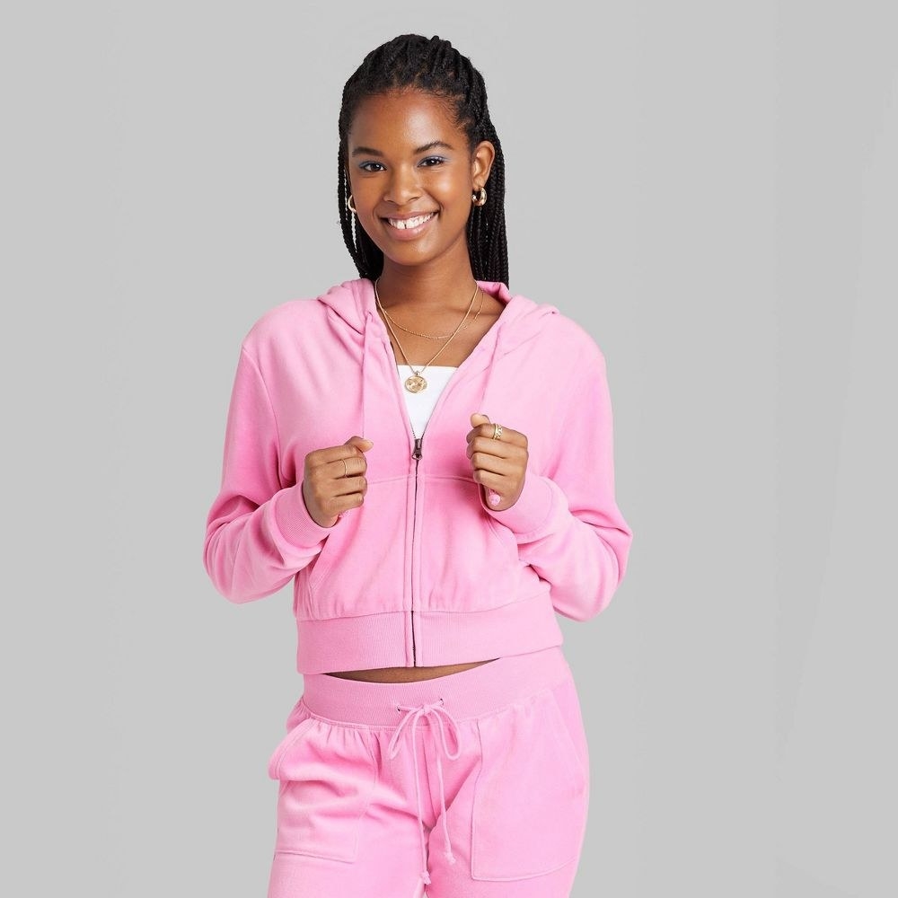 model wearing the zip up hoodie in pink