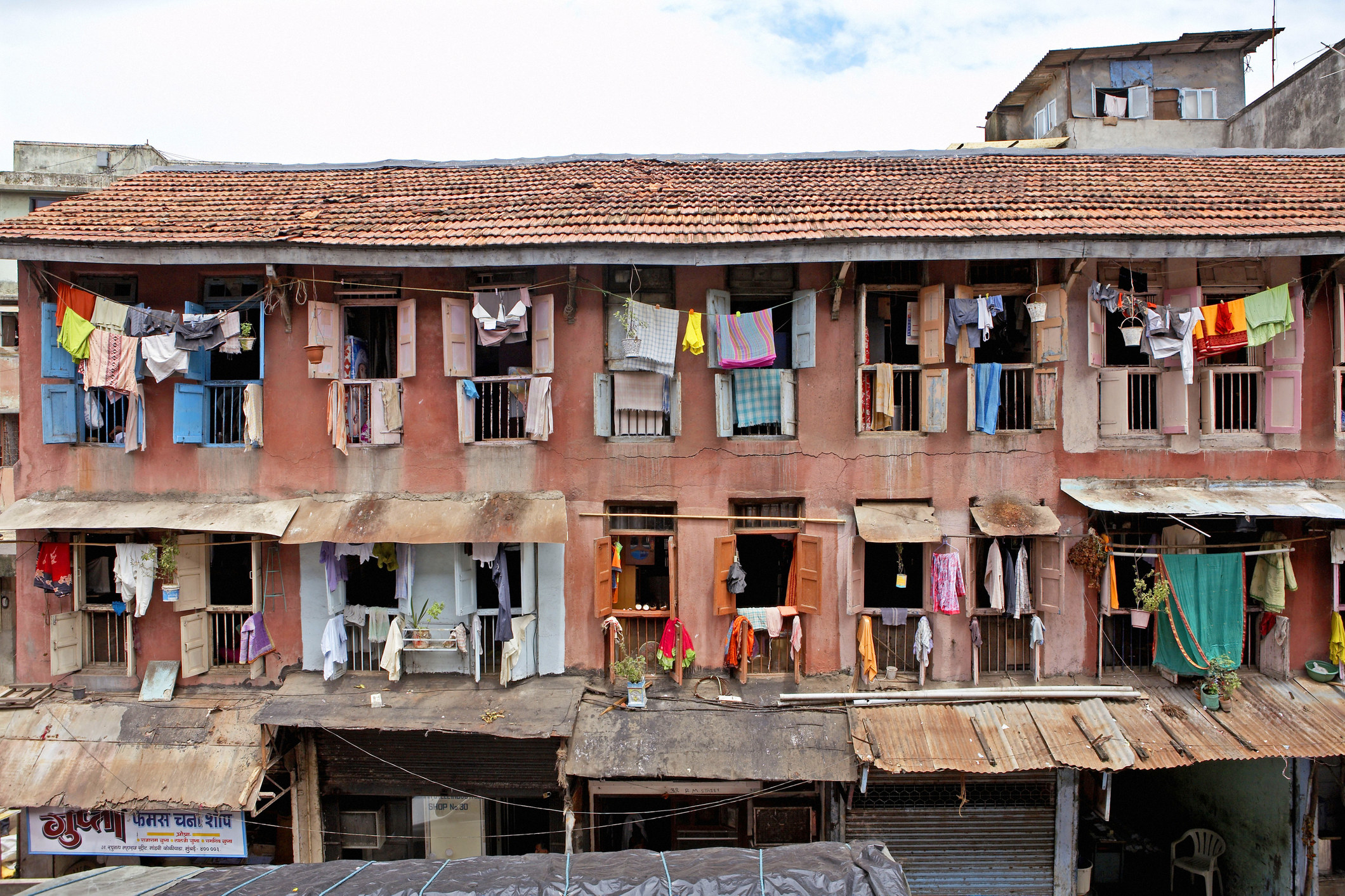 A multi-family home in India with laundry drying out the windows