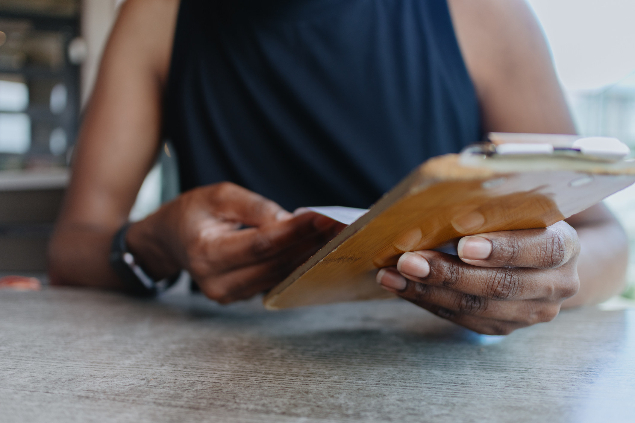 A woman reviewing the bill at a restaurant