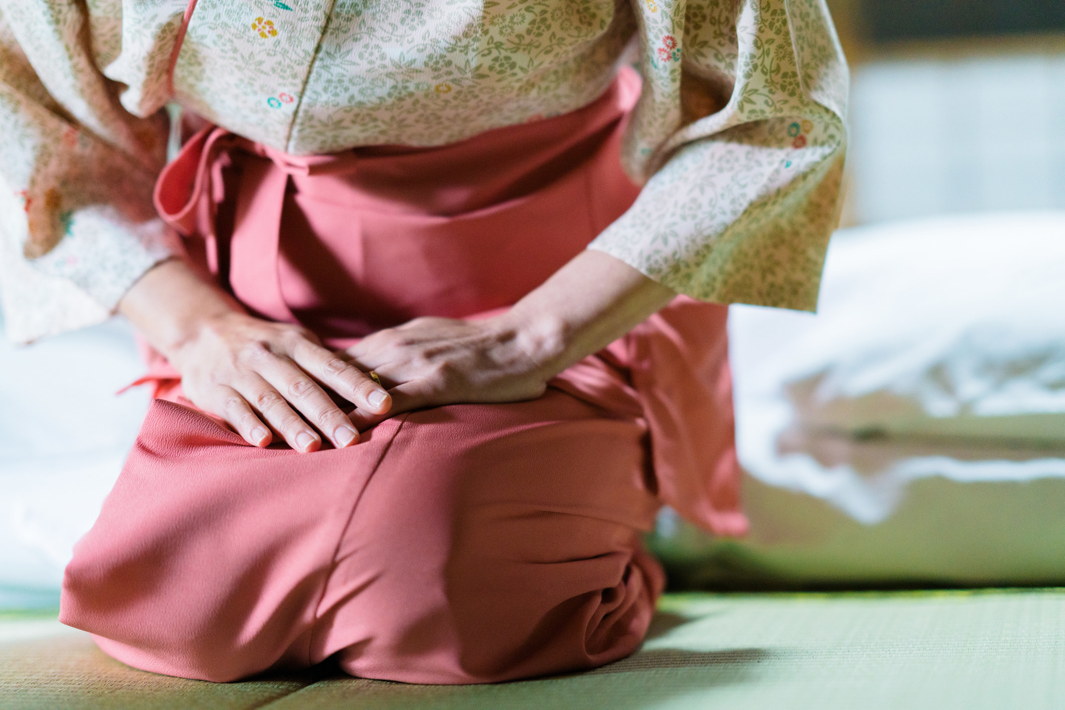 Unrecognizable Japanese inn owner greeting