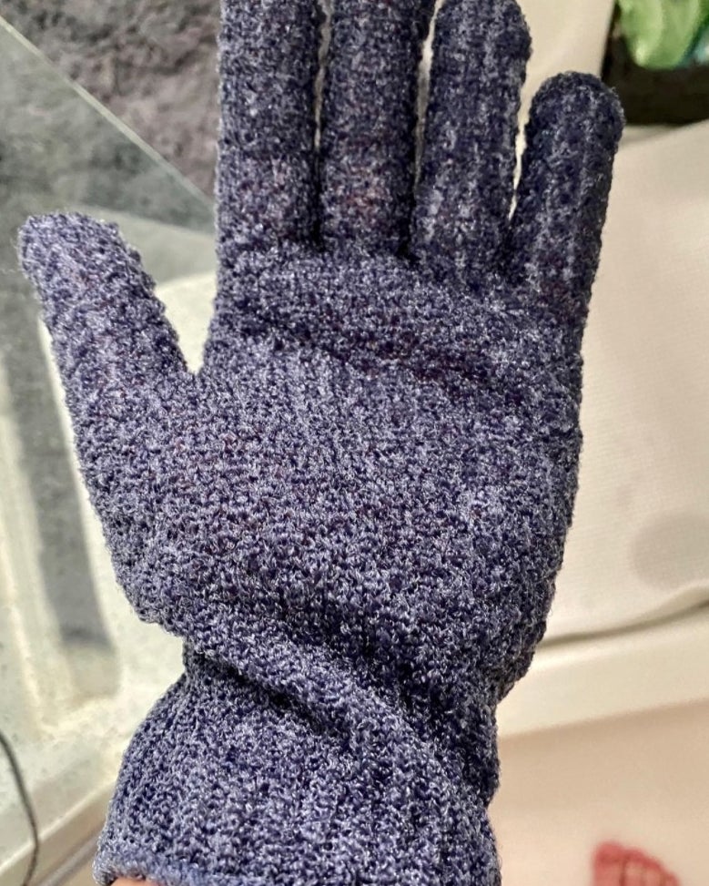 Reviewer wearing blue fingered glove in the shower