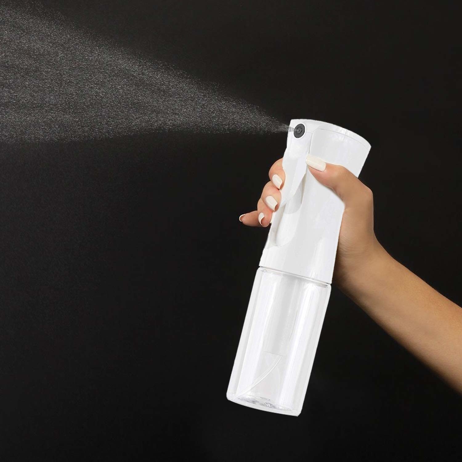 model holding the spray bottle and spraying it
