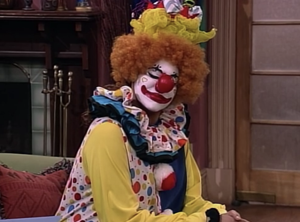 A clown sitting on a couch
