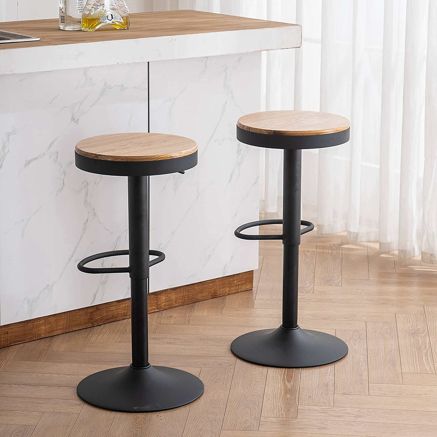the bar stools next to a kitchen counter