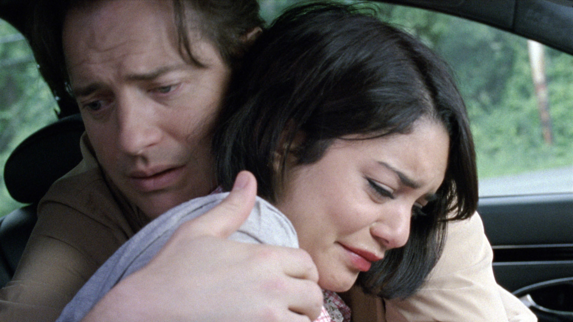 Brendan embracing Vanessa Hudgens in a car in a scene from the movie