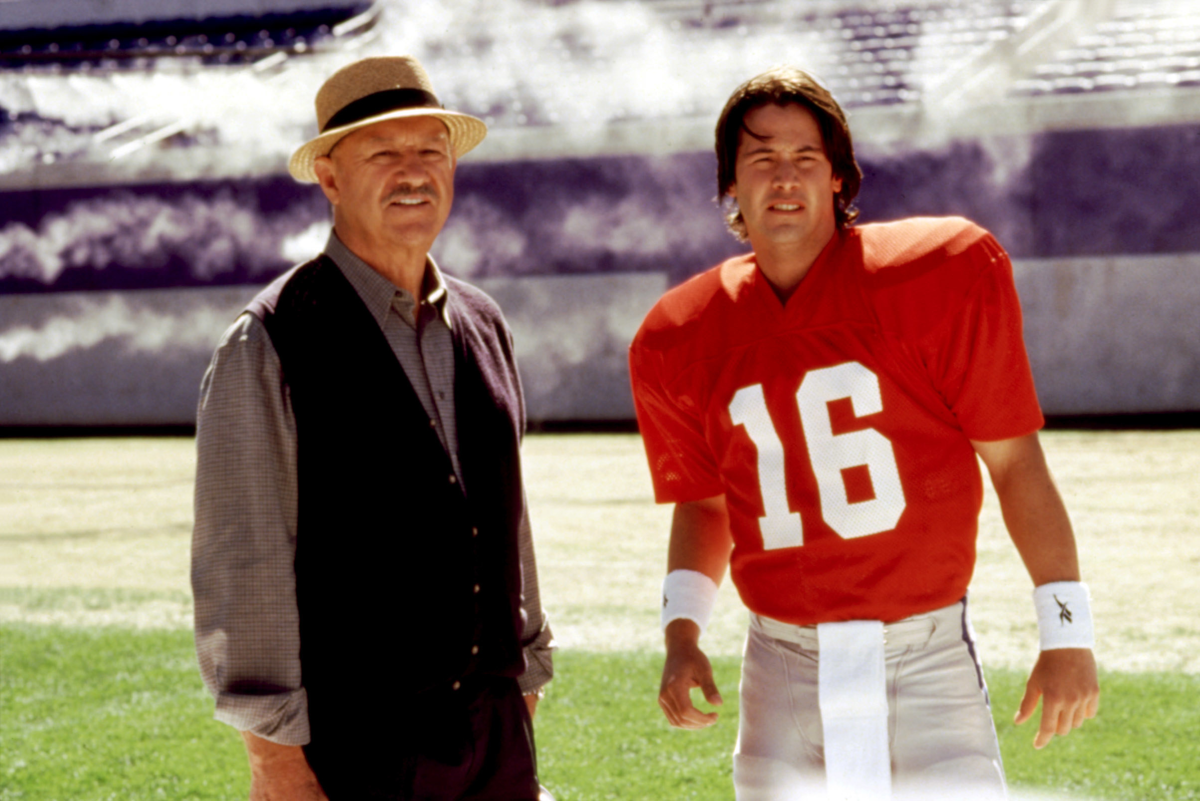 Gene standing with Keanu, who&#x27;s wearing a football uniform