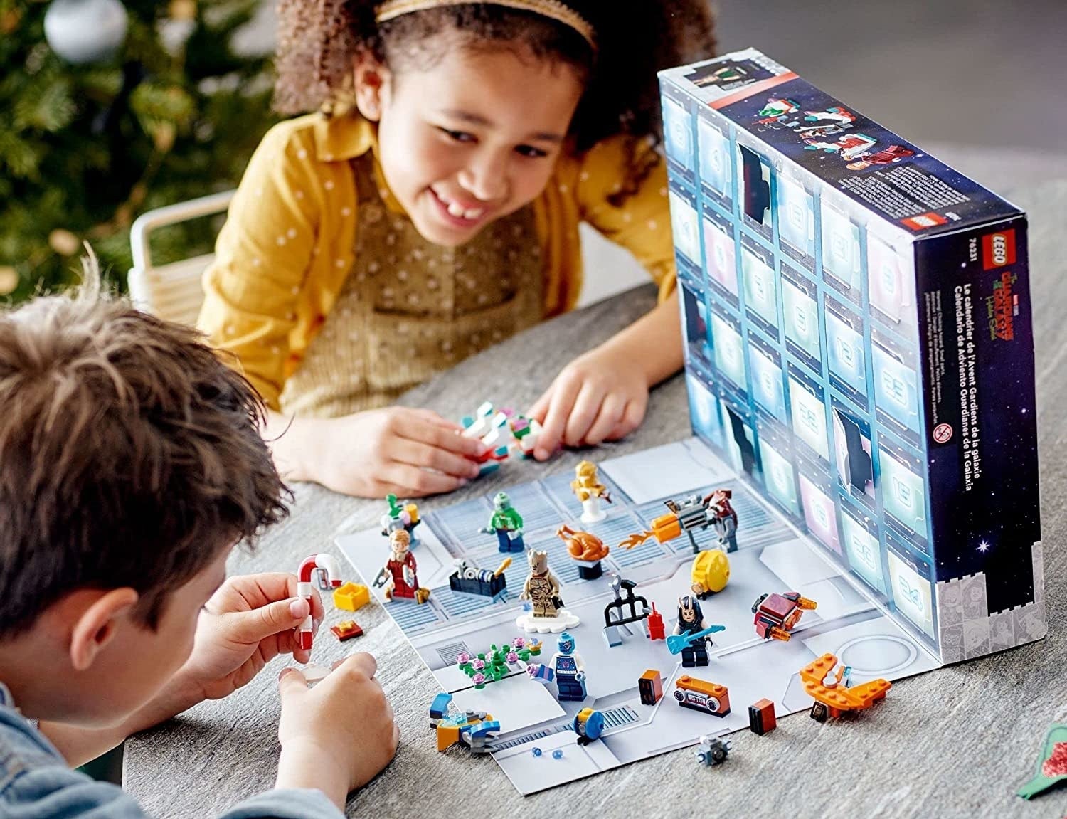 two children playing with a lego guardians of the galaxy advent calendar